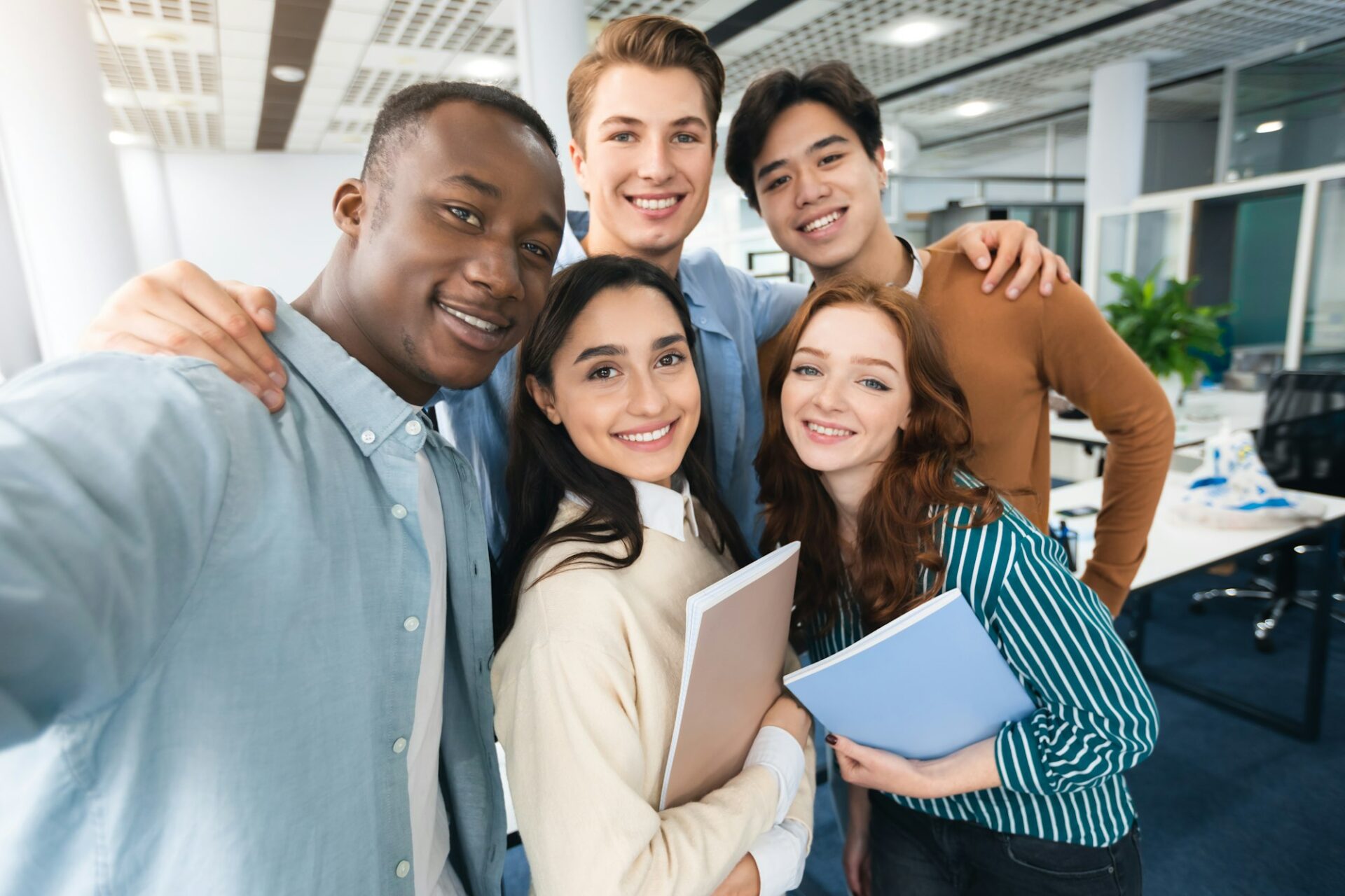 Happy international students taking selfie in university